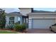 Charming single-story home with a well-maintained lawn, mature landscaping, and a two-car garage at 17880 Passionflower Cir, Clermont, FL 34714