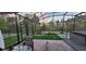 Outdoor patio features a dining table, screened-in enclosure, and a manicured lawn at 17880 Passionflower Cir, Clermont, FL 34714