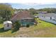 Aerial view of a home with a screened-in pool, shed, and fenced yard at 1916 Nicholas Pl, St Cloud, FL 34771