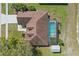 Overhead view of the house and backyard highlighting roof, screen enclosed pool, patio, landscaping, and shed at 1916 Nicholas Pl, St Cloud, FL 34771