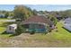 Beautiful backyard featuring a screen-enclosed pool, mature landscaping, privacy and storage shed at 1916 Nicholas Pl, St Cloud, FL 34771