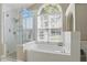 Bathroom featuring a soaking tub, large window, and a glass-enclosed shower at 1916 Nicholas Pl, St Cloud, FL 34771