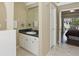 Bathroom featuring a vanity, tile flooring, and access to the bedroom and patio at 1916 Nicholas Pl, St Cloud, FL 34771