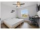 Simple bedroom featuring a full sized bed, desk area, ceiling fan, and bright windows at 1916 Nicholas Pl, St Cloud, FL 34771