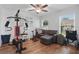 Bright bonus room with exercise equipment, sectional seating, ceiling fan, and lots of natural light at 1916 Nicholas Pl, St Cloud, FL 34771