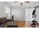 Bonus room with hardwood flooring, closet, and a large sectional couch at 1916 Nicholas Pl, St Cloud, FL 34771