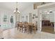 Bright dining room featuring tile floors, chandelier, and doors leading to the outdoor pool at 1916 Nicholas Pl, St Cloud, FL 34771
