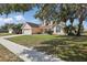 Inviting single-Gathering home with a lush front lawn and mature shade trees at 1916 Nicholas Pl, St Cloud, FL 34771