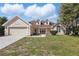 Charming single-Gathering home with a two-car garage and well-maintained front yard at 1916 Nicholas Pl, St Cloud, FL 34771