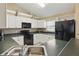 Well-lit kitchen with classic finishes, including white cabinets and a full suite of appliances at 1916 Nicholas Pl, St Cloud, FL 34771