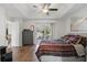 Spacious main bedroom features a tray ceiling, hardwood floors, and sliding glass doors at 1916 Nicholas Pl, St Cloud, FL 34771