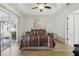 Relaxing main bedroom featuring a tray ceiling, sliding glass doors, hardwood floors, and neutral paint at 1916 Nicholas Pl, St Cloud, FL 34771