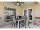 Covered patio with a ceiling fan and a dining set, perfect for outdoor meals at 1916 Nicholas Pl, St Cloud, FL 34771