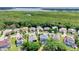 Aerial view of a residential neighborhood with lush greenery and a serene lake backdrop at 2165 The Oaks Blvd, Kissimmee, FL 34746