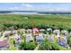 Aerial view of a residential neighborhood with lush greenery and a serene lake backdrop at 2165 The Oaks Blvd, Kissimmee, FL 34746
