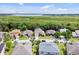 Aerial view of a residential neighborhood with lush greenery and a serene lake backdrop at 2165 The Oaks Blvd, Kissimmee, FL 34746