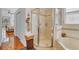 Bathroom showcases a glass shower, soaking tub, and decorative tile accents at 2165 The Oaks Blvd, Kissimmee, FL 34746