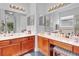 Bathroom boasts dual sinks with wood cabinets and ample counter space with a vanity at 2165 The Oaks Blvd, Kissimmee, FL 34746
