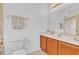 Bathroom with wood vanity, marble countertop, and a framed mirror over the sink at 2165 The Oaks Blvd, Kissimmee, FL 34746