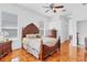 Bedroom includes a large wood bed, ceiling fan, and wood floors at 2165 The Oaks Blvd, Kissimmee, FL 34746