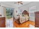 Bedroom featuring a wood bed, and a sliding glass door to the backyard at 2165 The Oaks Blvd, Kissimmee, FL 34746