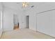 Carpeted bedroom with closet, ceiling fan, and bathroom access at 2165 The Oaks Blvd, Kissimmee, FL 34746