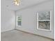 Bedroom with two windows providing natural light and neutral carpeted flooring at 2165 The Oaks Blvd, Kissimmee, FL 34746