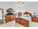 Bedroom featuring a wood bed, wood dressers, a ceiling fan, and windows at 2165 The Oaks Blvd, Kissimmee, FL 34746