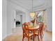 Formal dining room featuring a chandelier, large window, and decorative curtains at 2165 The Oaks Blvd, Kissimmee, FL 34746