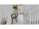 Inviting foyer featuring a decorative front door, tile flooring, and staircase at 2165 The Oaks Blvd, Kissimmee, FL 34746