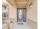 Inviting front entrance with a decorative glass door and a cozy seating area at 2165 The Oaks Blvd, Kissimmee, FL 34746