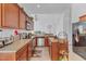 Functional kitchen featuring stainless steel appliances, ample counter space, and wood cabinetry at 2165 The Oaks Blvd, Kissimmee, FL 34746