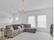 Lofted living room includes a comfortable sectional sofa and large windows at 2165 The Oaks Blvd, Kissimmee, FL 34746
