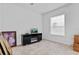 Bright living room features tile flooring, a large window, and a black TV stand at 2165 The Oaks Blvd, Kissimmee, FL 34746