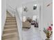 Open living room with a fireplace, high ceilings, and a staircase to the second floor at 2165 The Oaks Blvd, Kissimmee, FL 34746