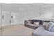 Bright loft area featuring neutral carpet, decorative chandeliers, and a cozy gray sectional sofa with decorative pillows at 2165 The Oaks Blvd, Kissimmee, FL 34746