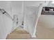 Carpeted staircase with white railing leading to the home's upper level at 2165 The Oaks Blvd, Kissimmee, FL 34746