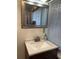 Bathroom with sink, large mirror, modern faucet and window with blinds at 2320 Amherst Ave, Orlando, FL 32804
