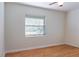 Bright bedroom with wood floors, a ceiling fan, and a window with blinds at 2320 Amherst Ave, Orlando, FL 32804