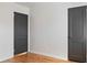 Bright bedroom with wood floors and two dark-colored doors at 2320 Amherst Ave, Orlando, FL 32804
