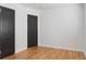 Bright bedroom with wood floors and two dark-colored doors at 2320 Amherst Ave, Orlando, FL 32804