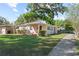 Inviting home showcasing a manicured lawn, a sidewalk and a quaint front porch at 2320 Amherst Ave, Orlando, FL 32804