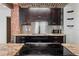 Modern kitchen features dark cabinets, granite countertops, and stainless steel appliances at 2320 Amherst Ave, Orlando, FL 32804