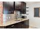 Modern kitchen features dark cabinets, granite countertops, and stainless steel appliances at 2320 Amherst Ave, Orlando, FL 32804