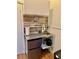 Compact kitchenette with stainless steel sink, mini-fridge, and wooden backsplash at 2320 Amherst Ave, Orlando, FL 32804