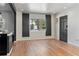 Sun-filled living room with sleek wood floors, and a large window with modern blinds at 2320 Amherst Ave, Orlando, FL 32804