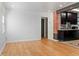Bright living room featuring wood floors and an exposed brick accent wall at 2320 Amherst Ave, Orlando, FL 32804