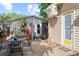 Patio with metal table and chairs, privacy fence, and lush landscaping at 2320 Amherst Ave, Orlando, FL 32804