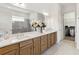 Bright bathroom featuring a double vanity, a large mirror, and a separate shower with glass door at 2658 Meadowedge Loop, St Cloud, FL 34772
