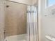 Bathroom tub and shower features a tiled wall with a shower head and bathtub faucet at 2658 Meadowedge Loop, St Cloud, FL 34772